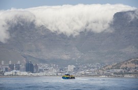 File: A ferry, with Table Mountain and part of the city in view, takes visitors back to the mainland after a tour of Robben Island.