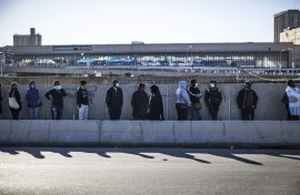 SASSA recipients waiting in a queue. AFP/Marco Longari
