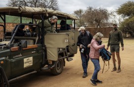 Tourists wearing face masks as a preventive measure against the spread of COVID-19 coronavirus get off from an open vehicle during a guided safari tour at the Dinokeng Game Reserve outside Pretoria, on 7 August 2020. 
