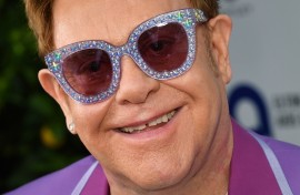 File: English singer-songwriter Elton John poses on the red carpet. AFP/Yann Coatsaliou 