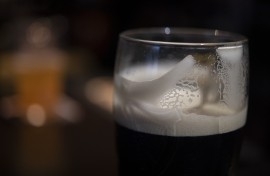 File: Foam coats the glass of a draft beer. AFP/Fred Tanneau