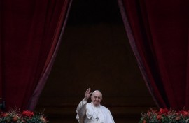 Pope Francis waves to the gathered faithful following his Christmas Urbi et Orbi blessing in St. Peter's Square at The Vatican on December 25, 2021 .