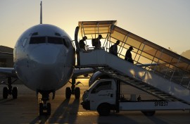 People go down from a plane at the international airport of Cape Town.