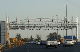 File: South African motorists drive towards the electronic toll plaza on the highway from Pretoria to Johannesburg. ALEXANDER JOE / AFP