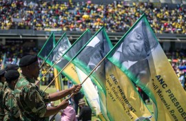 Soldiers hold banners bearing portraits of the former and current ANC presidents during the African National Congress's 106th-anniversary celebrations held at Absa Stadium in East London on January 13, 2018.