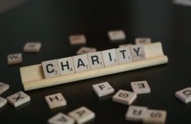 File image of the word 'charity' spelled in Scrabble tiles.