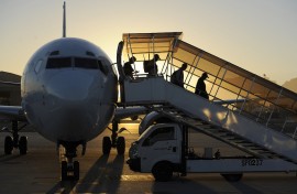 File: People go down from a plane at the international airport of Cape Town. AFP/Stephane de Sakutin