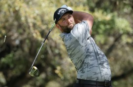 Top-ranked Jon Rahm of Spain lost his match but won his group Friday at the WGC Match Play, advancing to a Saturday knockout showdown against four-time major winner Brooks Koepka