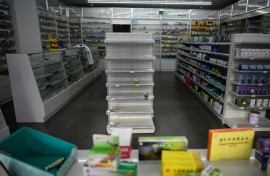 Empty shelves at a pharmacy in Beijing. Cities have been struggling to cope with surging infections since China dropped its zero-Covid policy