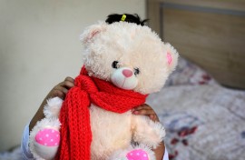 File: A displaced girl holds her teddy bear at an orphanage. AFP/Safin Hamed