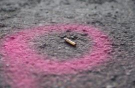 File: A spent casing is highlighted by the police at a crime scene. AFP/Guillem Sartorio