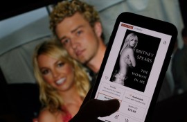 This illustration image shows the cover of Britney Spears' book "The Woman in Me" from an online retailer in front of a picture of Spears and Justin Timberlake. AFP/Chris Delmas