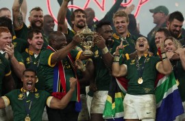 Captain Siya Kolisi and President Cyril Ramaphosa lift the Webb Ellis Cup as South Africa's players celebrate winning the France 2023 Rugby World Cup final match. AFP/Franck Fife