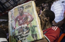File: A fan cries holding a portrait of the slain Bafana Bafana and Orlando Pirates captain Senzo Meyiwa. AFP/Marco Longari