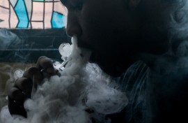 This photo illustration shows a customer smoking at a vape store.