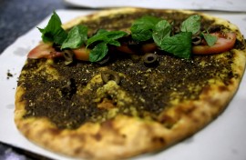 A traditional Lebanese manoushe flatbread topped with mint, tomatoes and olives. AFP/Joseph Eid