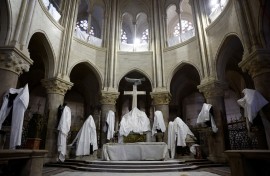 Statues protected by tarpaulins at the Notre-Dame de Paris Cathedral during its reconstruction. AFP/Pool