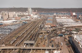 Trucks and cargo vessels are seen at the Port of Durban harbour.
