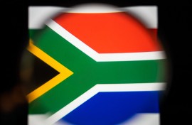File: View of the South African flag with a magnifying glass.