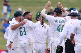South Africa’s Dane Piedt (L) takes the wicket of New Zealand’s Neil Wagner during day two of the second cricket Test match between New Zealand and South Africa Seddon Park in Hamilton on February 14, 2024.