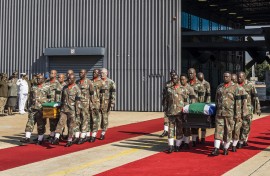 SANDF members carry the flag-draped coffins of Captain Simon Mkhulu Bone and Lance Corporal Irven Thabang Semono during a ceremony at the Waterkloof Air Force Base. AFP/Marco Longari