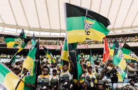 Supporters of the African National Congress (ANC) wave flags during the Election Manifesto launch. AFP/Rajesh Jantilal