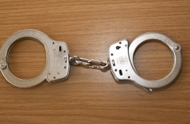 File: A pair of handcuffs on a table. Rolf Kremming/dpa Picture-Alliance via AFP