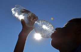 File: A boy drinks water from a plastic bottle. AFP/Picture-Alliance/Frank Hoermann/Sven Simon