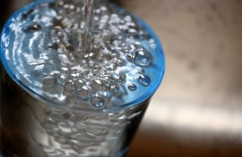File:  Tap water flows into a glass.  