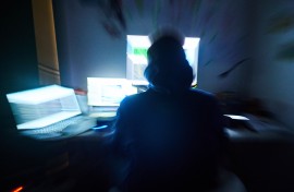 File: A person busy on computer screens. Annette Riedl/dpa Picture-Alliance via AFP