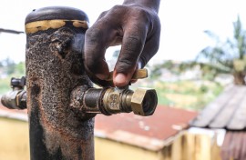 A person opens the tap. AFP