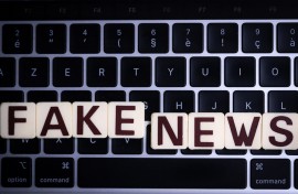File: This illustration photograph shows letters reading "fake news", against a laptop keyboard. AFP/Sebastien Bozon