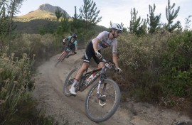 Matt Beers(R) of South Africa rides on his way to win Stage 4 of the 2024 Cape Epic mountain bike race. AFP/Rodger Bosch