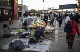 File: An informal vendor sets up his stall. AFP/Michele Spatari