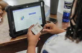 An IEC official checks an ID. AFP/Rajesh Jantilal