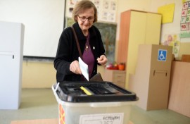 A woman casts her ballot to vote in the first round of the presidential elections, at a polling station in Skopje. AFP/Robert Atanasovski