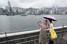Tourists from mainland China visit the Tsim Sha Tsui waterfront in Hong Kong. AFP/Peter Parks