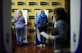 People mark their ballot papers as they vote in the South African general election, at the South African High Commission in central London. AFP/Benjamin Cremel