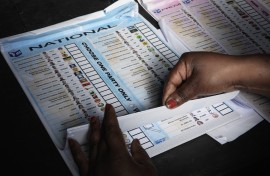 An Electoral Commission of South Africa (IEC) official prepares a ballot to be handed out to a voter. AFP/Gianluigi Guercia