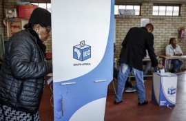 A voter marks her ballot papers in a voting booth. AFP/Phill Magakoe