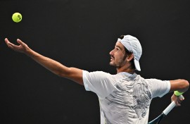 South Africa's Lloyd Harris serves against France's Quentin Halys during their men's singles match on day one of the Australian Open tennis tournament in Melbourne on January 14, 2024.