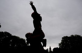 File: A father plays with his son in a park.