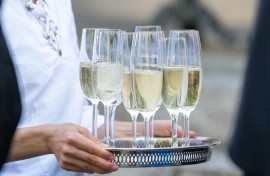 File: Glasses of sparkling wine are served on a tray. Silas Stein/dpa Picture-Alliance via AFP