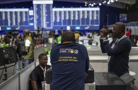 An IEC staff member leans against a booth at the National Results Center in Midrand. AFP/Michele Spatari