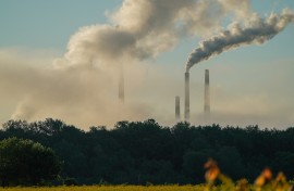 File: Pollution spewing from the stacks of a power plant. Jason Whitman/NurPhoto via AFP