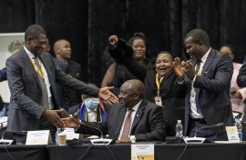 President of the African National Congress (ANC) Cyril Ramaphosa (C) is congratulated by Deputy president of the African National Congress (ANC) Paul Mashatile (L) after he was announced president after members of parliament voted during the first sitting of the New South African Parliament in Cape Town on June 14, 2024.