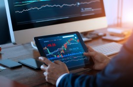 File: A businessman checking the stock market. Getty Images/ipopba