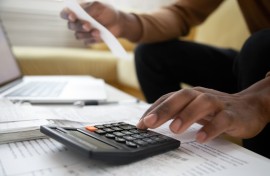 File: A man with a calculator checking bills.GettyImages/fizkes