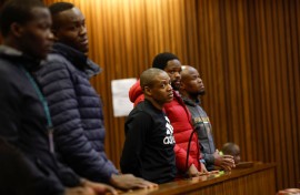 Five accused men in the Senzo Mayiwa murder trial stand in the dock at Pretoria High Court. Phill Magakoe/Gallo Images via Getty Images