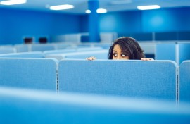File: An office worker eavesdropping in cubicle room. Getty Images/ferrantraite